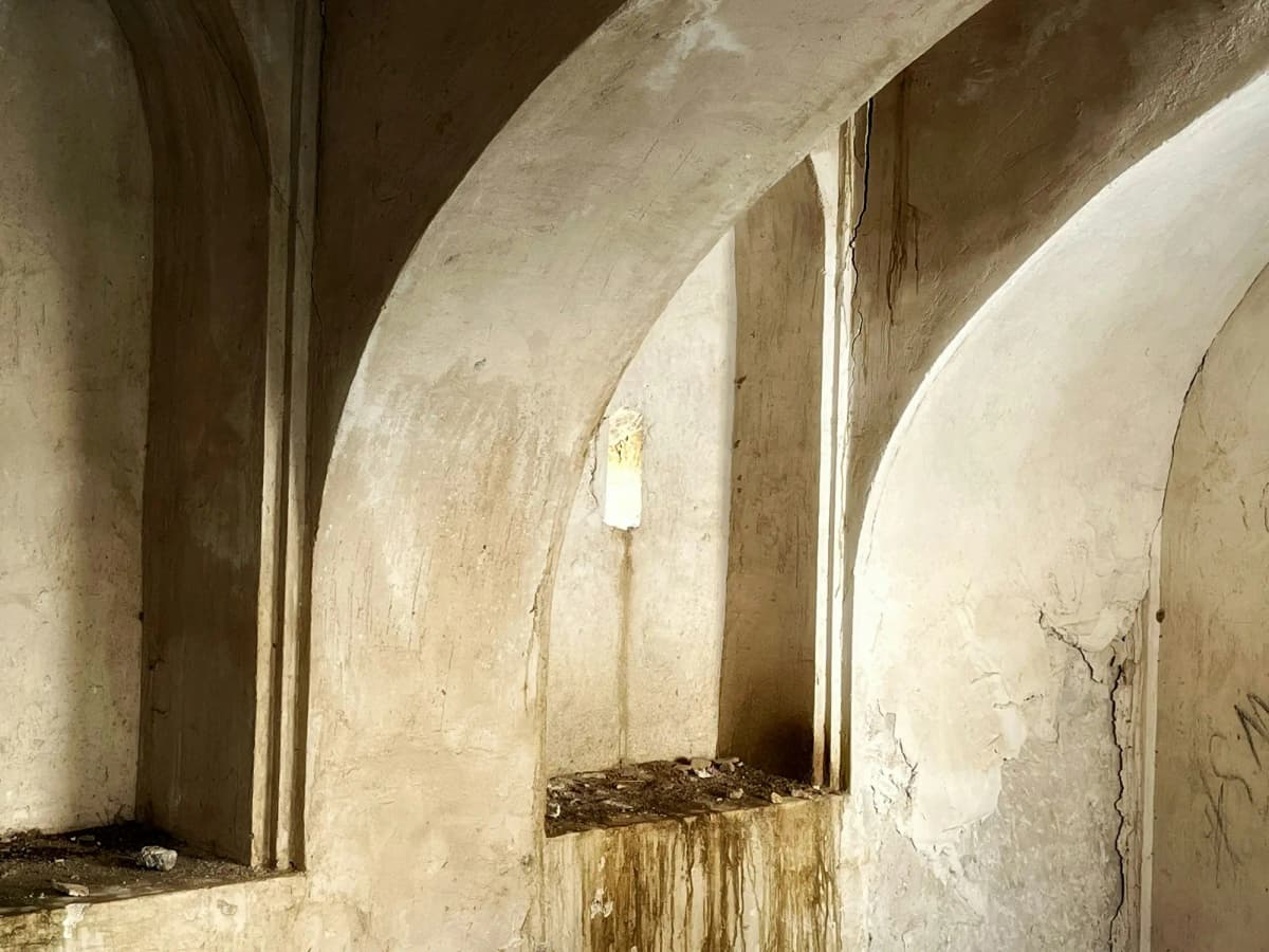 Weathered plaster arches in low side light